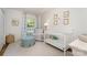 Bright Bedroom with crib, comfortable chair, and soft, natural light at 935 Trentle Ct, Charlotte, NC 28211