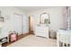 Bedroom boasts a white dresser with a gold mirror and a pink striped rug leading to a closet at 935 Trentle Ct, Charlotte, NC 28211
