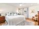 Bright bedroom featuring a king bed, ceiling fan, and natural light from a window with shutters at 935 Trentle Ct, Charlotte, NC 28211