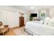 Spacious bedroom featuring a TV, white bedding, ceiling fan, and access to natural light at 935 Trentle Ct, Charlotte, NC 28211