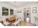 Bright breakfast nook with wood table, white chairs, and natural light at 935 Trentle Ct, Charlotte, NC 28211