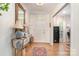Bright foyer featuring hardwood floors, elegant console table, and a beautiful chandelier at 935 Trentle Ct, Charlotte, NC 28211