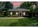 Charming one-story brick home featuring a beautifully landscaped yard and a welcoming front entrance at 935 Trentle Ct, Charlotte, NC 28211