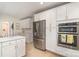 Spacious kitchen with stainless steel appliances, white cabinetry, and open layout at 935 Trentle Ct, Charlotte, NC 28211