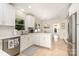 Bright kitchen with white cabinets, stainless steel appliances, and island at 935 Trentle Ct, Charlotte, NC 28211