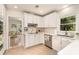 Well-lit kitchen featuring white cabinets, modern appliances, and tile flooring at 935 Trentle Ct, Charlotte, NC 28211