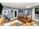 Living room with a leather sofa, golf bag, a large TV, and sports memorabilia on the wall at 935 Trentle Ct, Charlotte, NC 28211