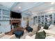 Inviting living room with hardwood flooring, a brick fireplace, and custom built-in shelving at 935 Trentle Ct, Charlotte, NC 28211