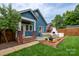 Charming blue home with a beautifully landscaped backyard and outdoor seating area at 1008 Vanizer St, Charlotte, NC 28208