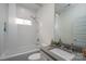 Bright bathroom with white subway tile, updated fixtures, and a shower-tub combo at 1008 Vanizer St, Charlotte, NC 28208