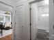 Hallway view leads to bedroom and updated bathroom at 1008 Vanizer St, Charlotte, NC 28208