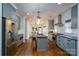 Bright kitchen boasts stainless appliances, gray cabinetry, and a central island with bar seating at 1008 Vanizer St, Charlotte, NC 28208