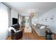 Comfortable living room featuring hardwood floors, ample seating, a modern chandelier, and bright windows at 1008 Vanizer St, Charlotte, NC 28208