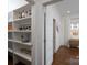 Walk-in pantry features built-in shelving, providing ample storage space for an organized home at 1008 Vanizer St, Charlotte, NC 28208