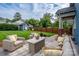 Inviting patio with outdoor seating, stylish rug, and a charming shed in a lush, green backyard at 1008 Vanizer St, Charlotte, NC 28208
