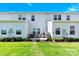 Backyard view with patio furniture, grill, and well-manicured lawn, perfect for outdoor relaxation and entertaining at 103 Blackstone Ct # C, Statesville, NC 28677