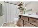 Bathroom with a white shower curtain, wood vanity with white sink, and tile floors at 103 Blackstone Ct # C, Statesville, NC 28677
