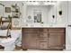 Bathroom featuring a dual sink vanity with dark wood cabinets and a large mirror at 103 Blackstone Ct # C, Statesville, NC 28677