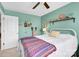 Bright bedroom with a white metal bed frame, colorful throw blanket, and shelf accents at 103 Blackstone Ct # C, Statesville, NC 28677