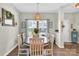 Cozy dining room featuring an oval table with seating for six, enhanced by a decorative chandelier and natural light at 103 Blackstone Ct # C, Statesville, NC 28677