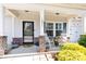 Inviting front porch featuring rocking chairs, potted plants, and decorative accents for a cozy and welcoming entrance at 103 Blackstone Ct # C, Statesville, NC 28677
