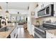 Modern kitchen featuring stainless steel appliances, stone countertops, and an open layout to the living area at 103 Blackstone Ct # C, Statesville, NC 28677
