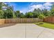 Spacious backyard featuring a concrete patio area, well-maintained grass, and a wooden fence at 113 Prince St, Belmont, NC 28012