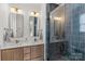 A stylish bathroom with dual sinks, quartz countertop, hardwood cabinets, and blue tiled shower at 113 Prince St, Belmont, NC 28012