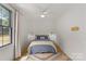 Bedroom with light hardwood floors, light walls, and a modern ceiling fan with a view at 113 Prince St, Belmont, NC 28012