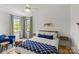 Bedroom with hardwood floors, ample natural light, a ceiling fan, and stylish furniture at 113 Prince St, Belmont, NC 28012