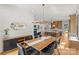 Bright, open dining room with a modern chandelier, wood floors, and an open view to the kitchen at 113 Prince St, Belmont, NC 28012
