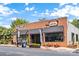 The String Bean Social exterior with red brick, black awning, and outdoor patio seating at 113 Prince St, Belmont, NC 28012