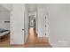Bright hallway with white trim, hardwood floors, and multiple doors leading to other rooms at 113 Prince St, Belmont, NC 28012