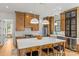 Bright kitchen featuring a large island with bar seating, stainless steel appliances, and wooden cabinets at 113 Prince St, Belmont, NC 28012