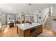 Open-concept kitchen with large island, dining area, and living room, creating a welcoming space for entertaining at 113 Prince St, Belmont, NC 28012