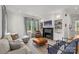 Spacious living room featuring a cozy fireplace, large windows, and comfortable seating at 113 Prince St, Belmont, NC 28012