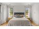 A sunlit main bedroom with light hardwood floors, bright walls, and a view to the outdoors at 113 Prince St, Belmont, NC 28012