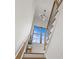 A modern staircase with wooden steps, dark railings, and a large window showcasing blue skies at 113 Prince St, Belmont, NC 28012