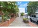 Street view of a sidewalk lined with planters, trees, and parked cars on a clear day at 113 Prince St, Belmont, NC 28012