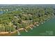 Stunning aerial view of lakefront homes with private docks nestled among lush trees with lake views in the background at 116 Ivy Hollow Ln, Mooresville, NC 28117
