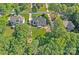 Aerial view of home showcasing lush green lawn, landscaping, and charming exterior, surrounded by mature trees and greenery at 116 Ivy Hollow Ln, Mooresville, NC 28117