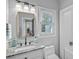 Bright bathroom featuring a granite countertop, modern fixtures, and a gold framed mirror, with natural light at 116 Ivy Hollow Ln, Mooresville, NC 28117