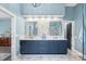 Elegant bathroom with double vanity, decorative mirrors, tiled accent wall, and stylish blue cabinetry at 116 Ivy Hollow Ln, Mooresville, NC 28117