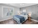 Comfortable bedroom featuring hardwood floors, a serene color palette, and ample natural light from a large window at 116 Ivy Hollow Ln, Mooresville, NC 28117