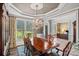 Formal dining room with decorative chandelier, large windows, and an adjacent doorway at 116 Ivy Hollow Ln, Mooresville, NC 28117