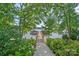 Scenic wooden path leading to a dock on the water with trees, flowers and shrubbery surrounding it at 116 Ivy Hollow Ln, Mooresville, NC 28117