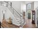 Bright foyer with a staircase, chandelier, and hardwood floors, creating an elegant entrance at 116 Ivy Hollow Ln, Mooresville, NC 28117