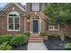 Close-up of the front entrance with arched windows and lush landscaping at 116 Ivy Hollow Ln, Mooresville, NC 28117