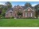 Charming brick two-story home features a well-manicured lawn and inviting front entrance at 116 Ivy Hollow Ln, Mooresville, NC 28117