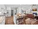 Spacious kitchen island with counter seating and open view into the living room with fireplace at 116 Ivy Hollow Ln, Mooresville, NC 28117